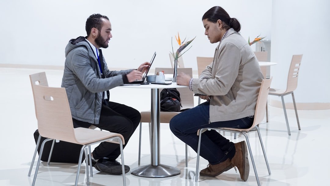 Manager and employee having supportive one-on-one conversation in private office setting